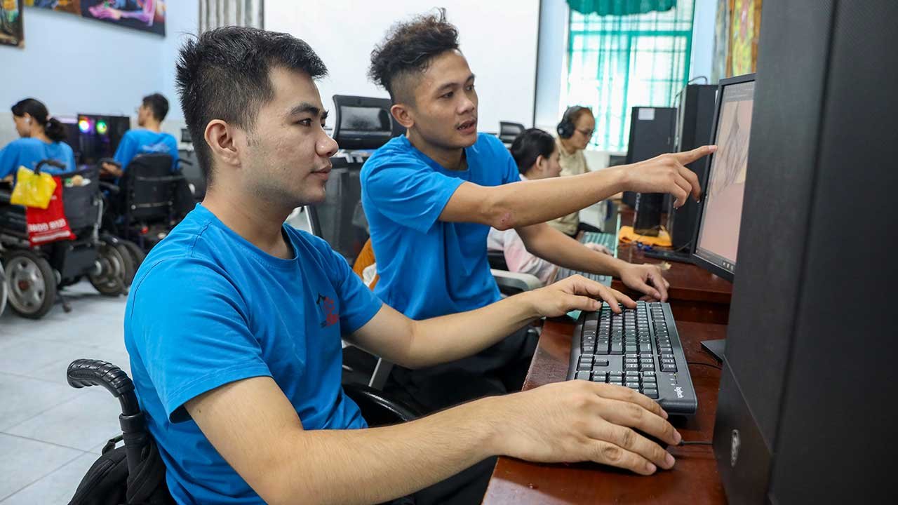 Disabled students working together on computers